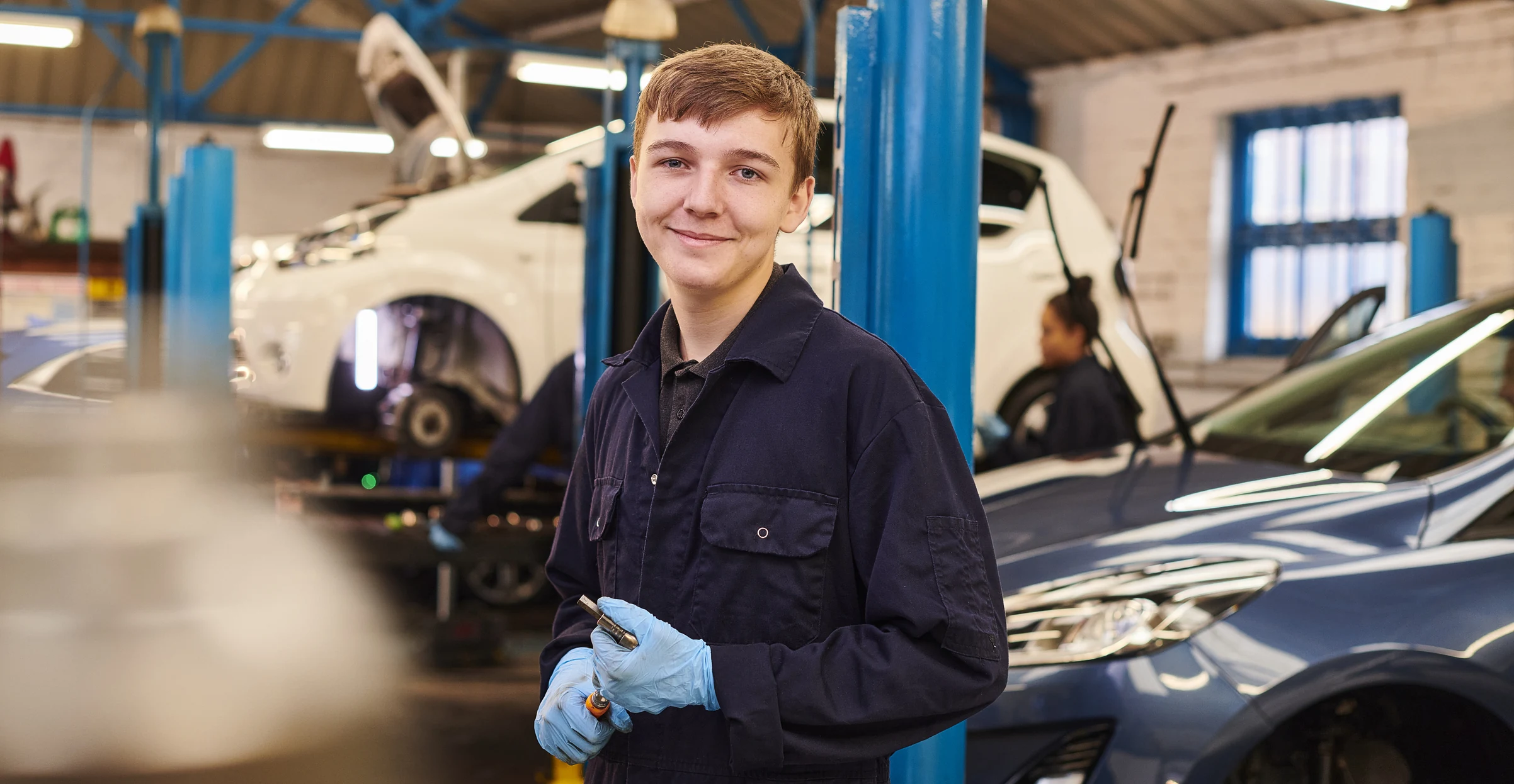 young garage apprentice in the workshop
