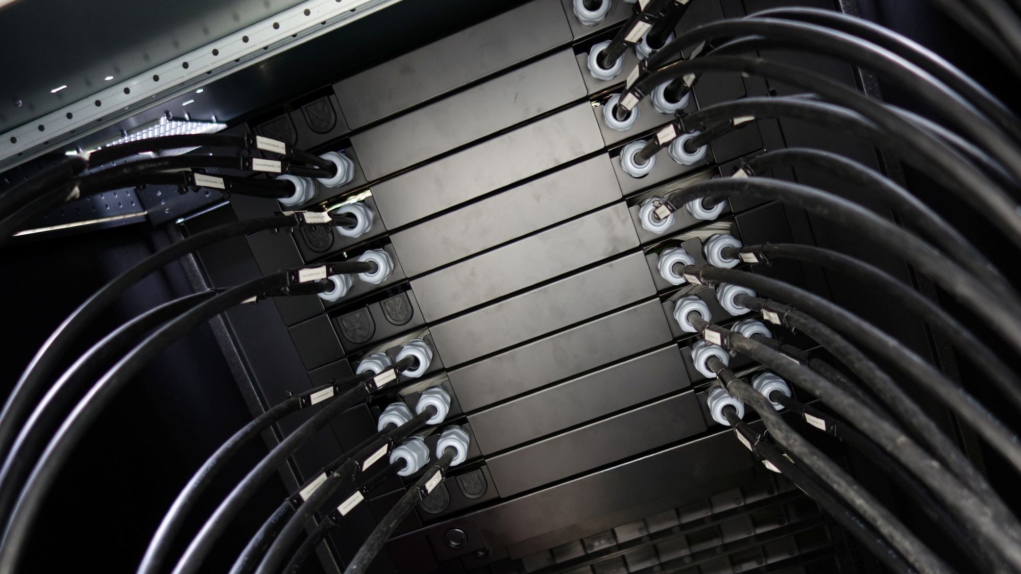 This image showcases a detailed view of electrical connections and cables inside a rack, highlighting the industrial technology infrastructure and organization.